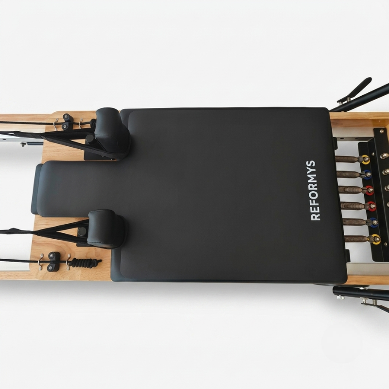 Birds eye view of Reformys Pilates Reformer Mat in Black on a Pilates reformer