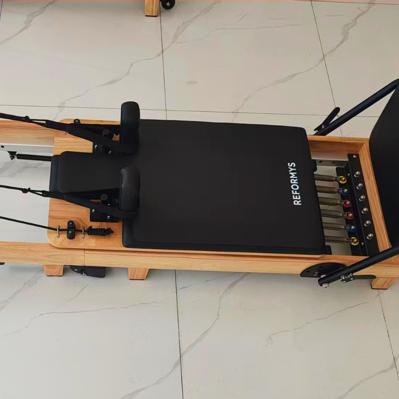 Birds eye view of Reformys Pilates Reformer Mat in Black inside marble floor studio