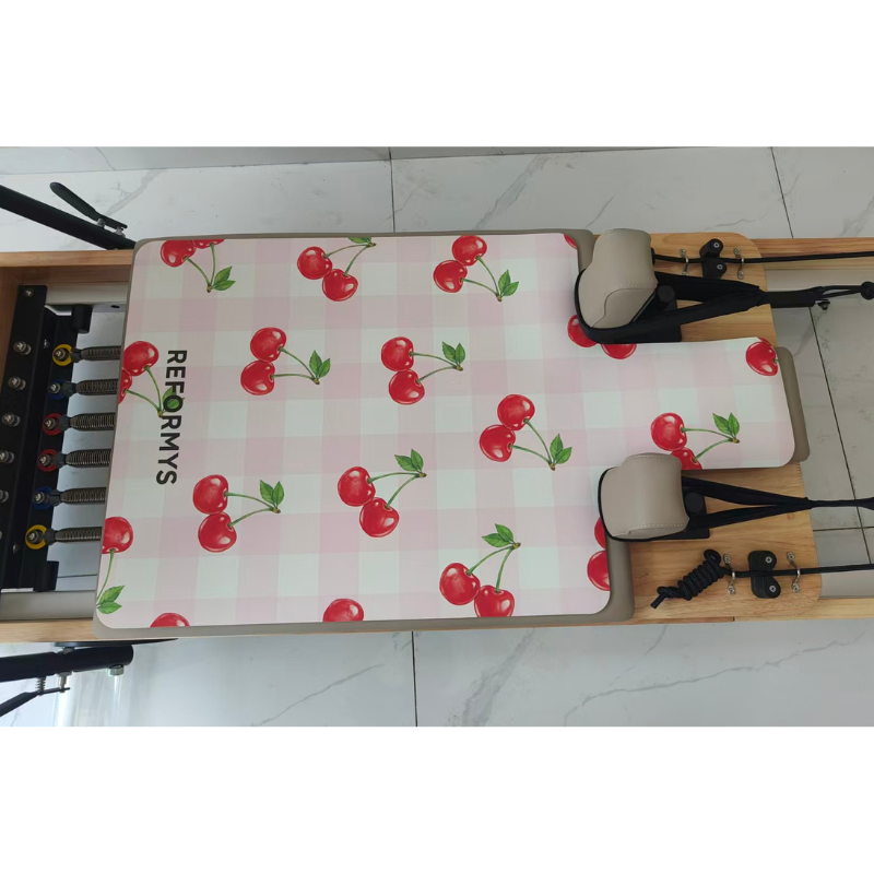 Birds eye view of Reformys Pilates Reformer Mat in Cherry Crush on a Pilates reformer machine