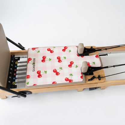 Side view of the Reformys Pilates Reformer Mat in Sweet Rebel on a Pilates reformer machine