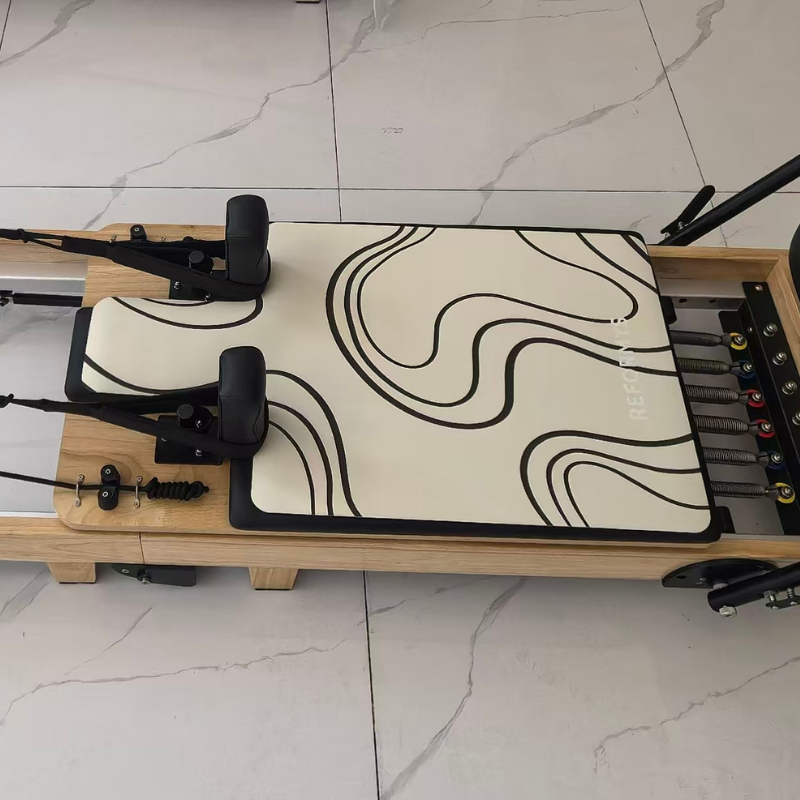 Top view of Reformys Pilates Reformer Mat in Contour on a Pilates reformer inside marble floor studio