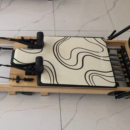 Top view of Reformys Pilates Reformer Mat in Contour on a Pilates reformer inside marble floor studio