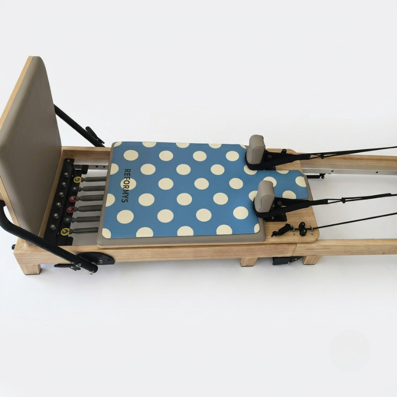 Reformys Pilates Reformer Mat in Ocean Dot on a Pilates reformer machine
