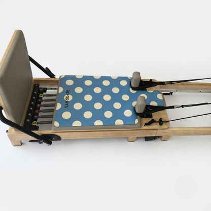 Reformys Pilates Reformer Mat in Ocean Dot on a Pilates reformer machine